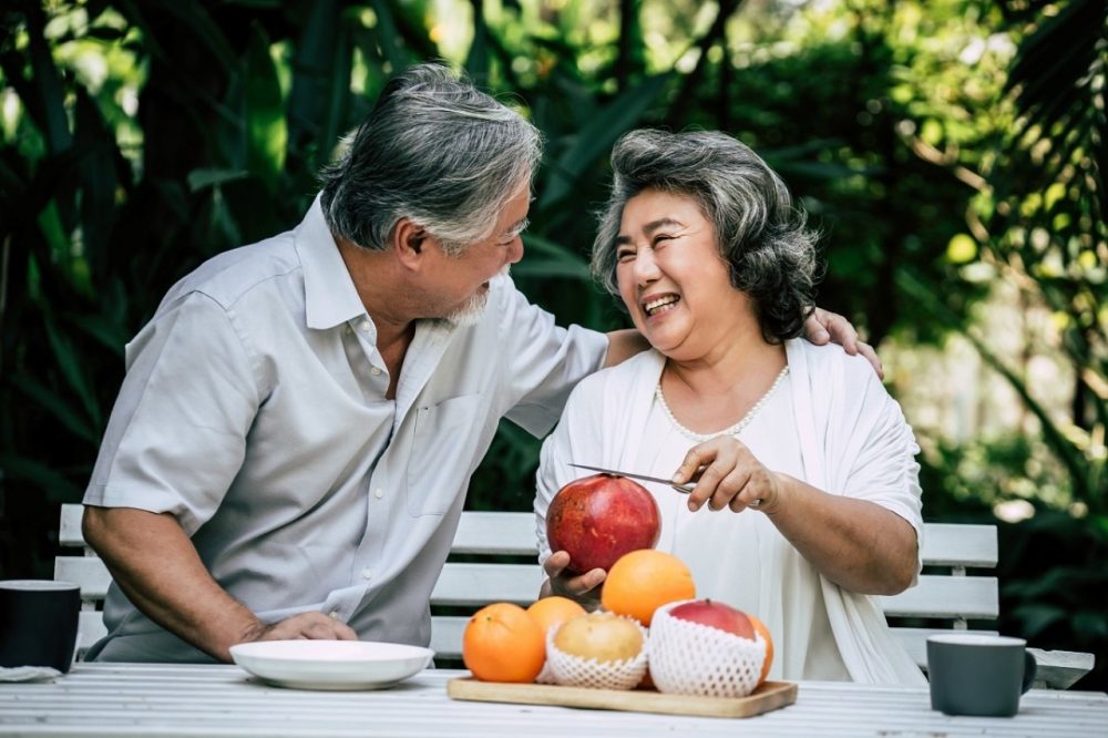 elderly couples playing eating some fruit resize